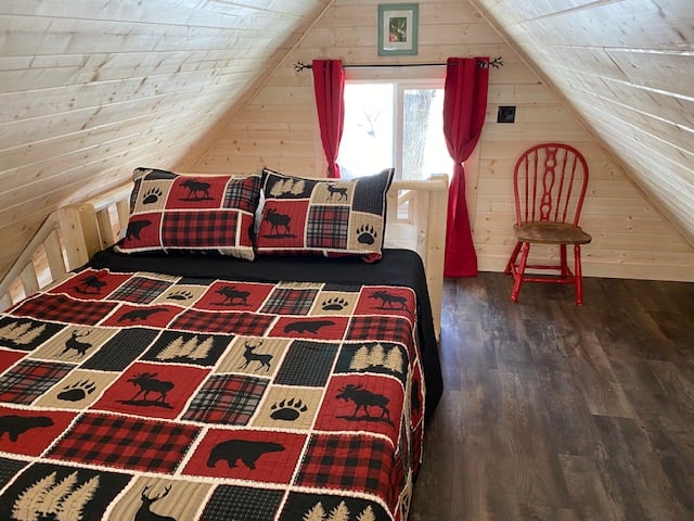 view of a bed room with a bed and a window