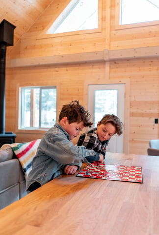 two boys playing snake and ladder