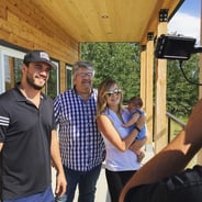 two men and a women holding her baby